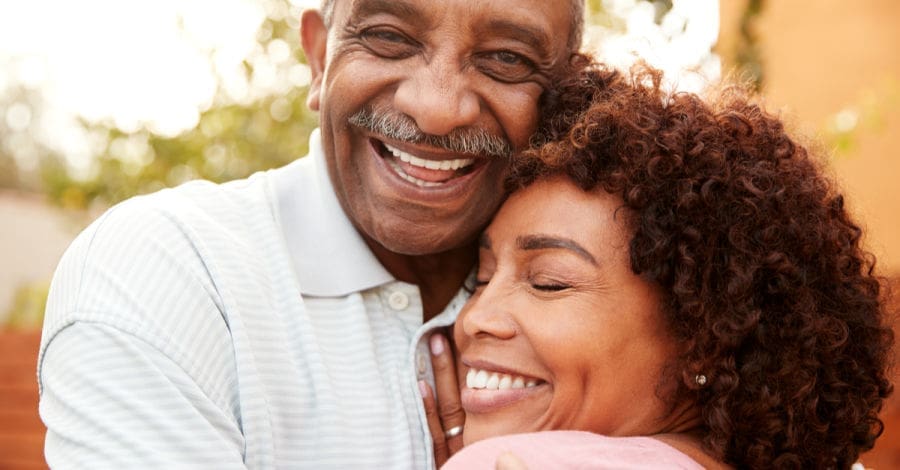 older couple smiling Melrose dental implants