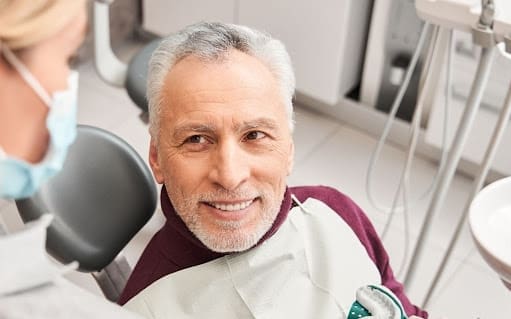 smiling man having dental check up