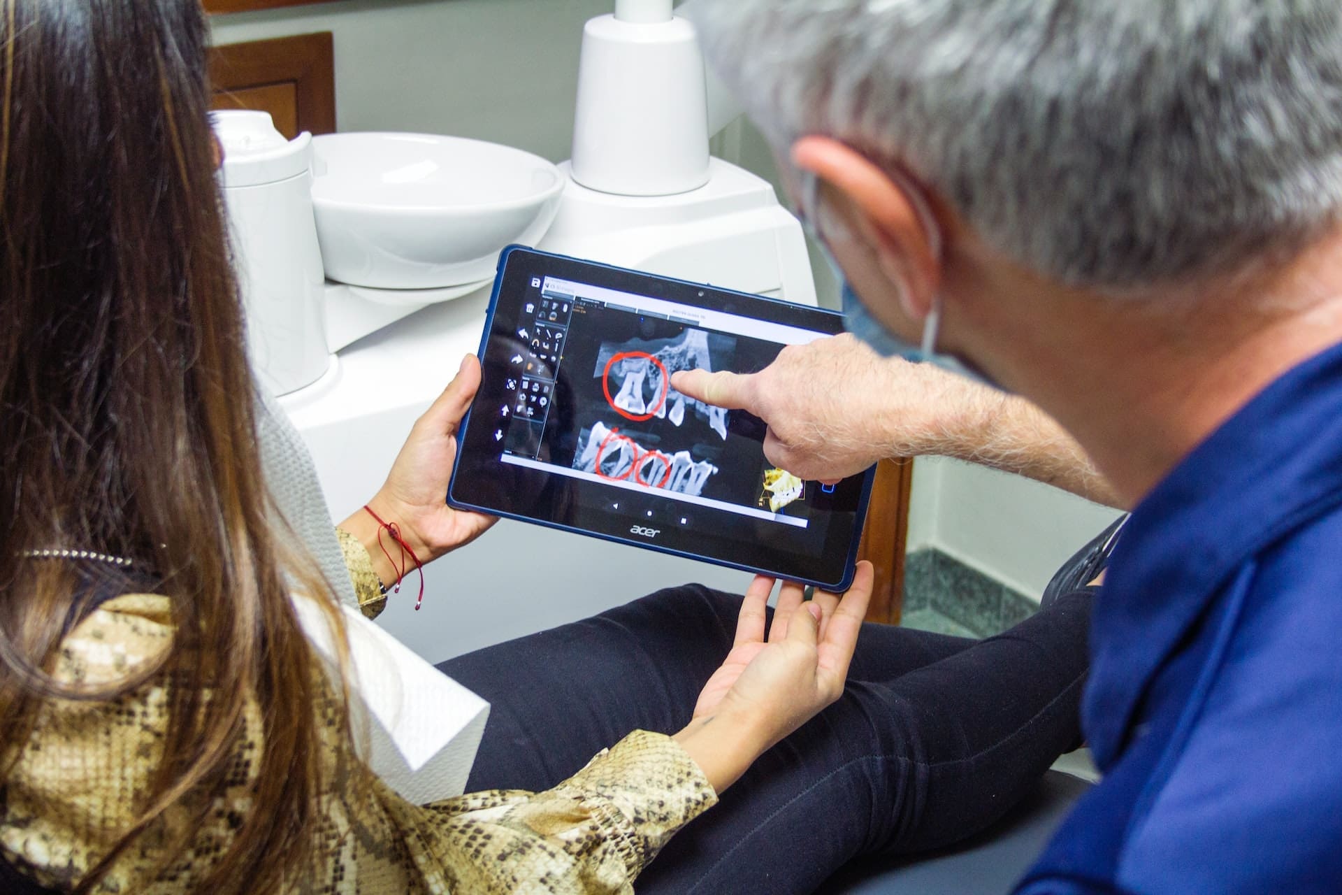 Dentist showing a patient an x ray of their teeth