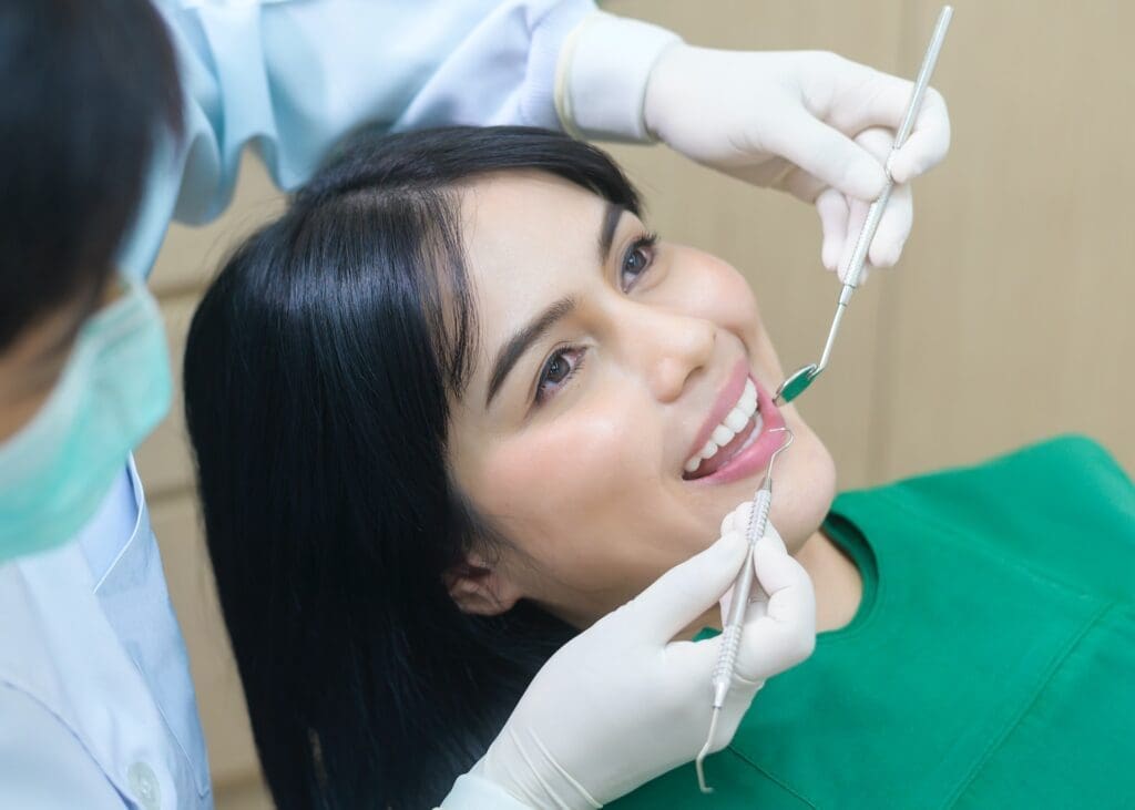 A dental crown being placed over a tooth, illustrating the process of restoring a damaged tooth's shape and strength.