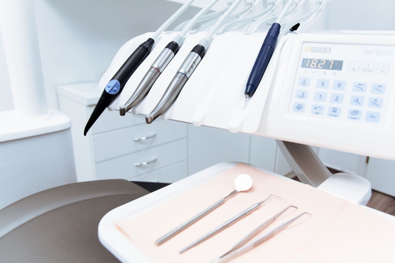 A variety of cosmetic dentistry tools laid out on a clean sterile tray in dental treatment room