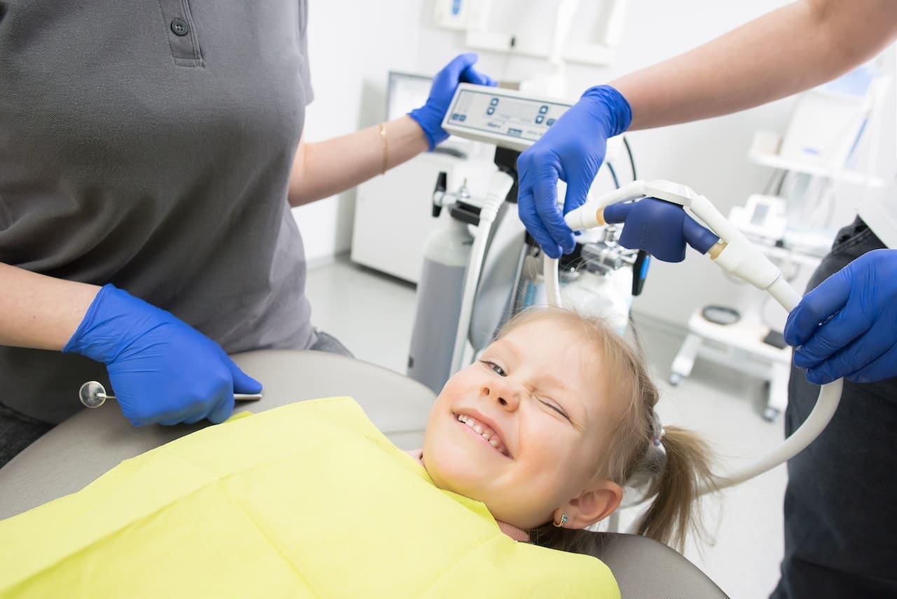 Smiling child sitting in dental chair