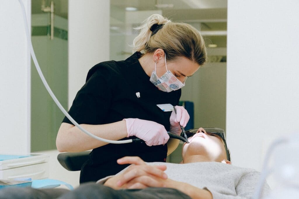 Cosmetic dentist performing a dental procedure on a patient