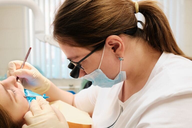 Women receiving dental sealant treatment.