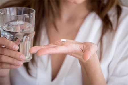 Lady prepares to take over-the-counter pain reliever