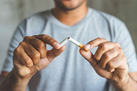 Man breaks cigarette