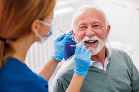 Man smiles at dentist