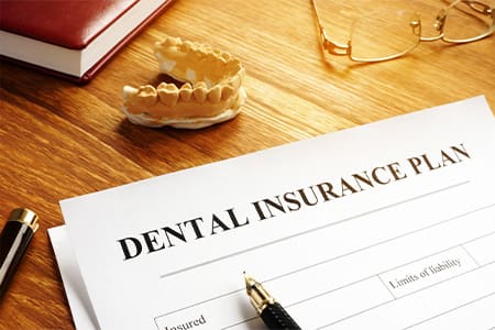 Patient in Melrose looking at dental insurance for dental implants
