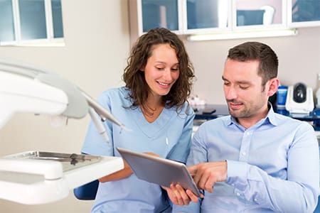 Patient in Melrose talking to dentist about Dental implants