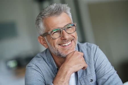 Close-up of man with glasses smiling