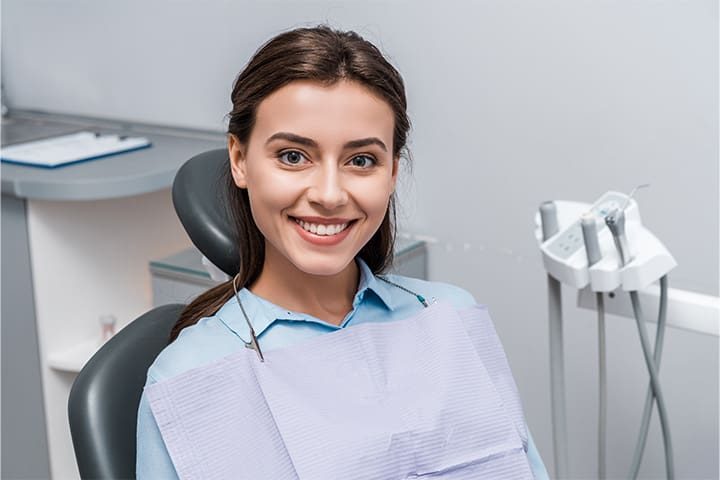 Female dental patient sitting and smiling