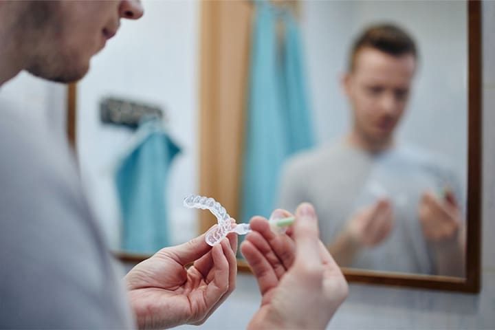 Male patient performing at-home whitening